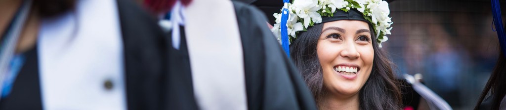  a woman smiling at graduation after completing her degree