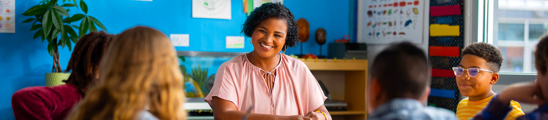 Toya S., a woman with short curly hair and a pink blouse, <a href=