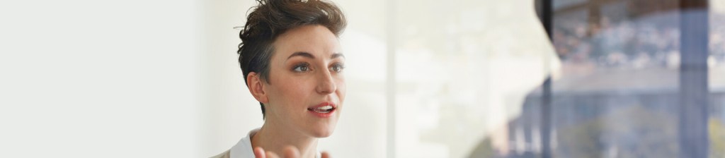 woman looking at person across from her engaged in conversation