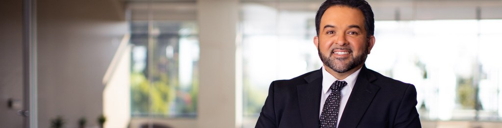 man in suit smiling into camera