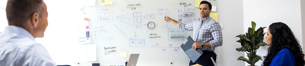 Person doing a presentation at a whiteboard showing the Key Factors to Land an AI Job