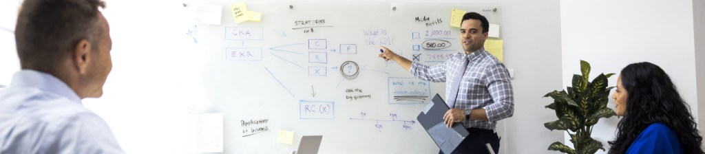 person presenting at whiteboard