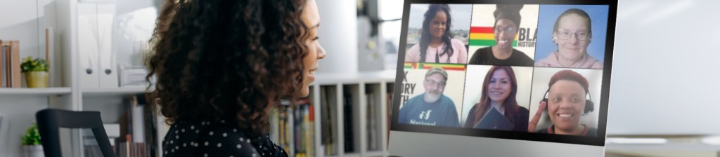 woman looks at laptop screen with a video call on it